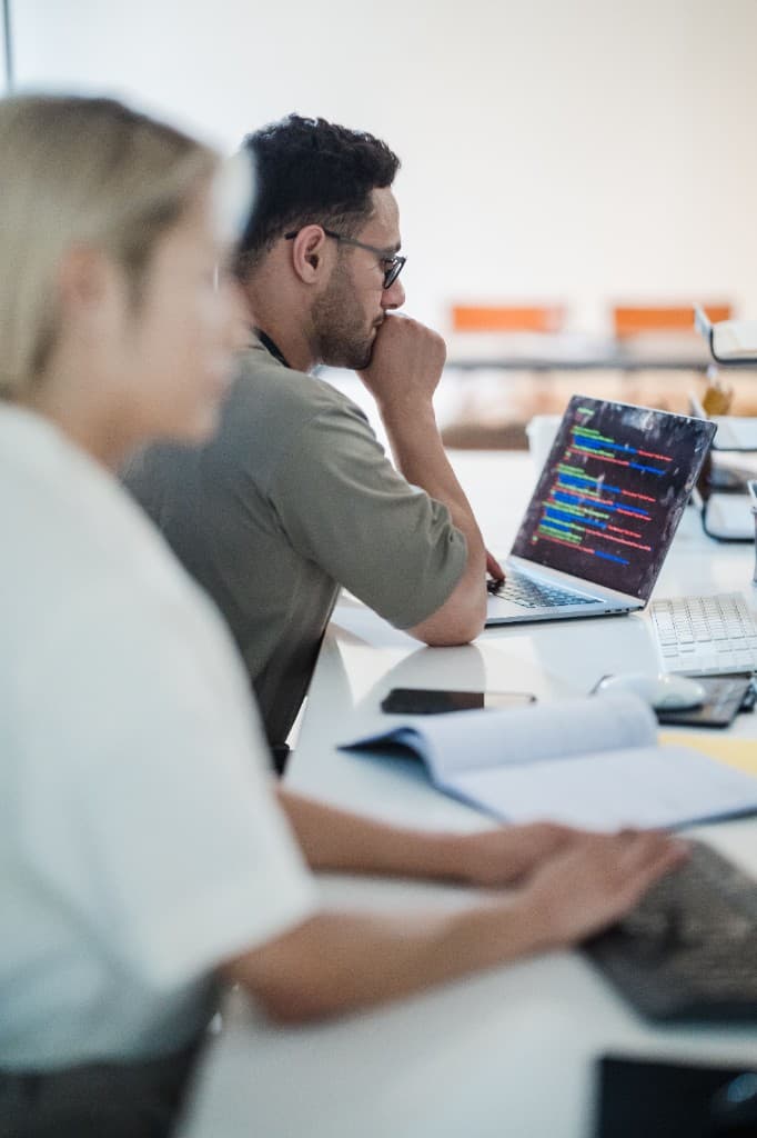 An engineer at the desk, working through the product in code.